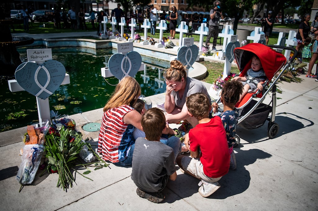 Mourners gather near crosses bearing the names of those killed in the mass shooting at Robb Elementary School in Uvalde, Texas, on Thursday, two days after the killings. Thursday was supposed to have been the last day of school in Uvalde; instead, grieving relatives are planning funerals. Photograph: Meridith Kohut/The New York Times