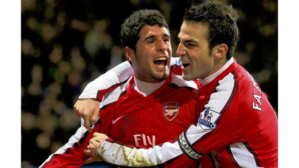 Arsenal's Fran Merida celebrates after scoring his side's second goal with team-mate Cesc Fabregas - scorer of their first - in yesterday's 2-0 Premier League victory over Bolton Wanderers at the Reebok Stadium.