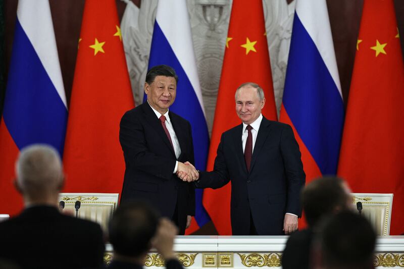 Russian President Vladimir Putin and China's President Xi Jinping shake hands after delivering a joint statement following their talks at the Kremlin in Moscow on March 21, 2023.  (Photo by MIKHAIL TERESHCHENKO/SPUTNIK/AFP via Getty Images)