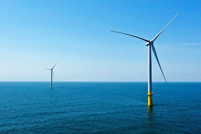 Two Siemens Gamesa offshore wind turbines stand off the coast of Virginia Beach, Virginia (Steve Helber/AP)