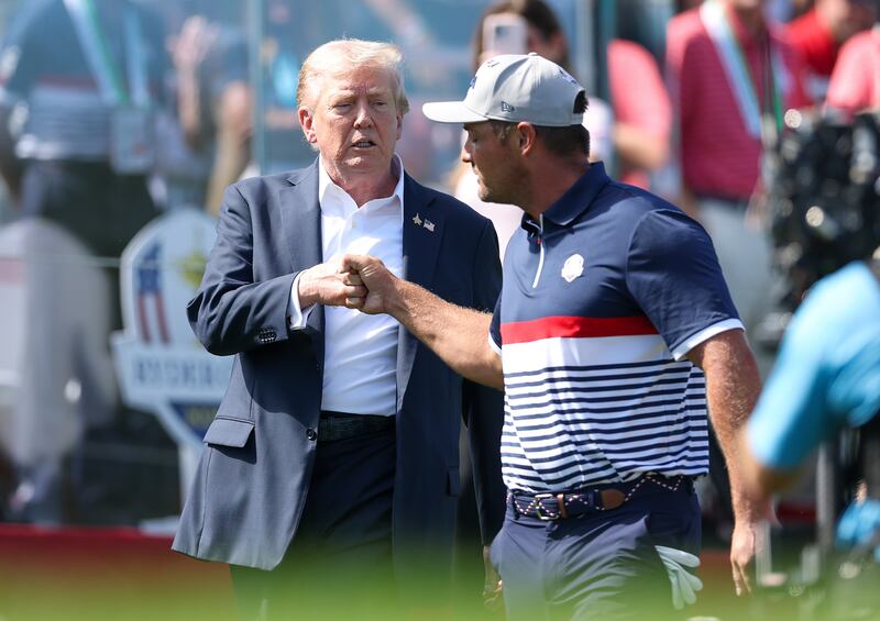 US president Donald Trump fist bumps Bryson DeChambeau. Photograph: Richard Heathcote/Getty