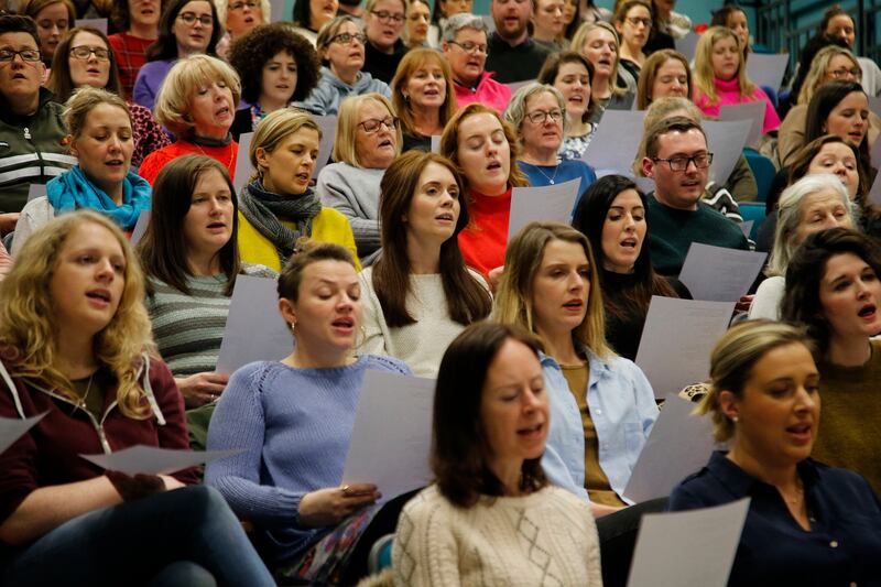 Members of the choir read from  hymm sheets. Song selections comes from a range of genre including classics from the 1980s and 1990s right up to modern pop, rock and R&B tracks. Photograph Nick Bradshaw for The Irish Times