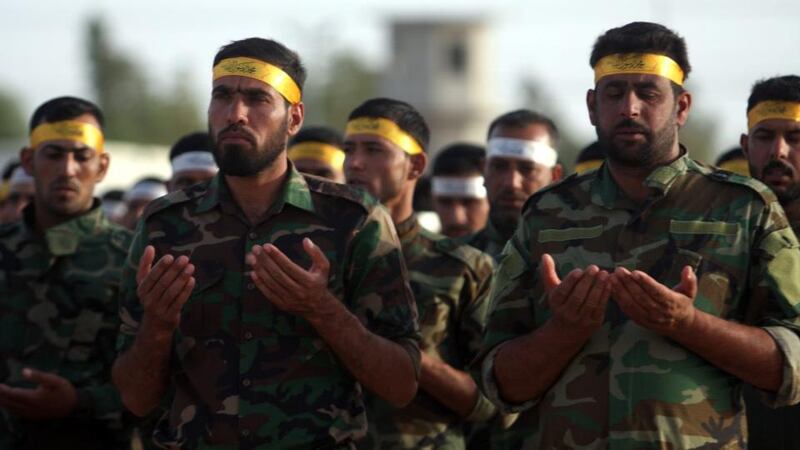 Members of a Shia militia pray near Ramadi. Photograph:  Alaa  Al-Shemaree/ EPA