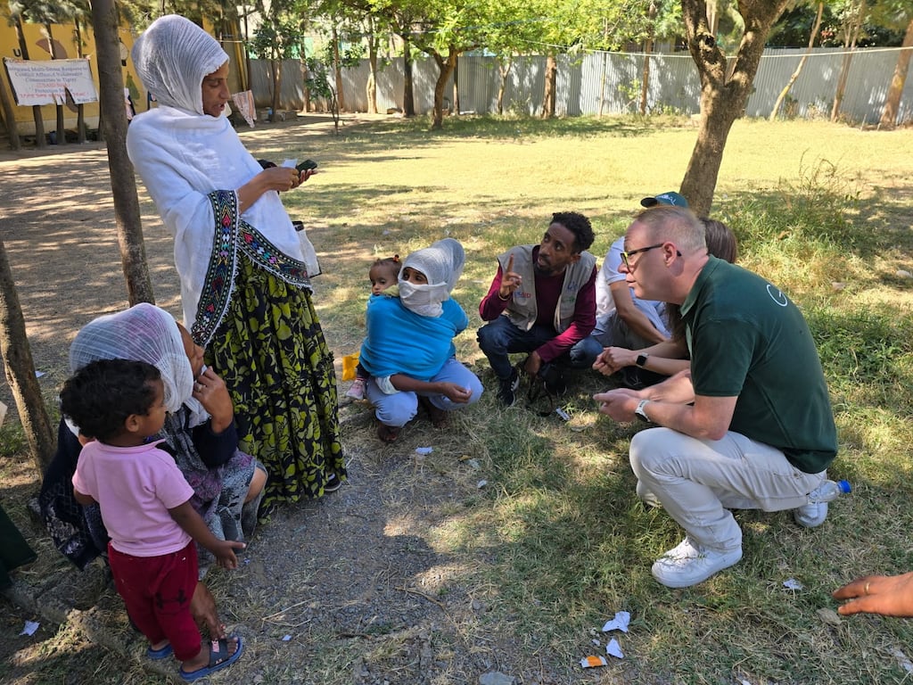 Mark O'Toole talks to mothers and children at intake facility for food aid in Tigray, Ethiopia