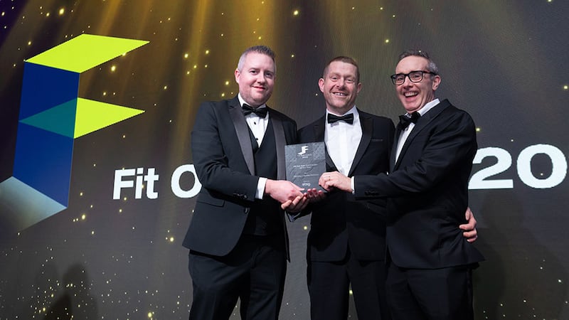 Shaun Bonner, managing director at Etag Ireland, presents the fit out sub-contractor of the year award to Cathal Manning and Mark Buckley, Manning & Buckley Electrical