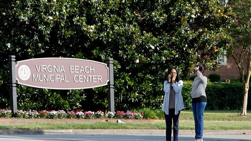Women wait by an entrance to the Virginia Beach Municipal Center  following the shooting in the public works building on Friday. Photograph:  AP