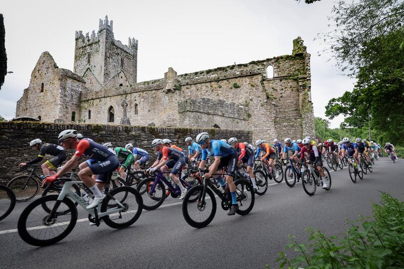 The main bunch passing Jerpoint Abbey, Co Kilkenny, on the way to Enniscorthy during Friday's third stage of Rás Tailteann. Photograph: Lorraine O'Sullivan  