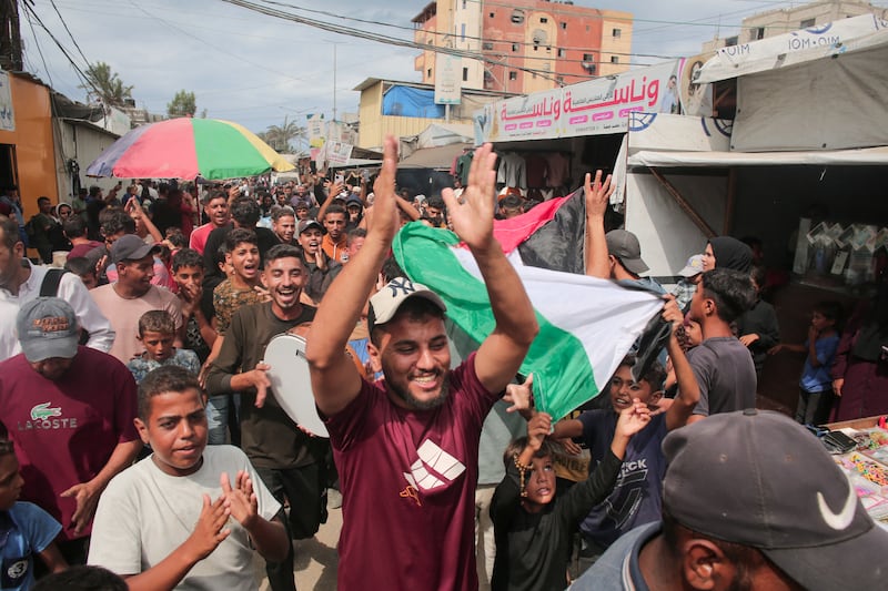 Palestinians celebrate in Rafah, Gaza Strip, on Thursday following news of a new Gaza ceasefire deal. Photograph: Abdelrahman Rashad/Getty