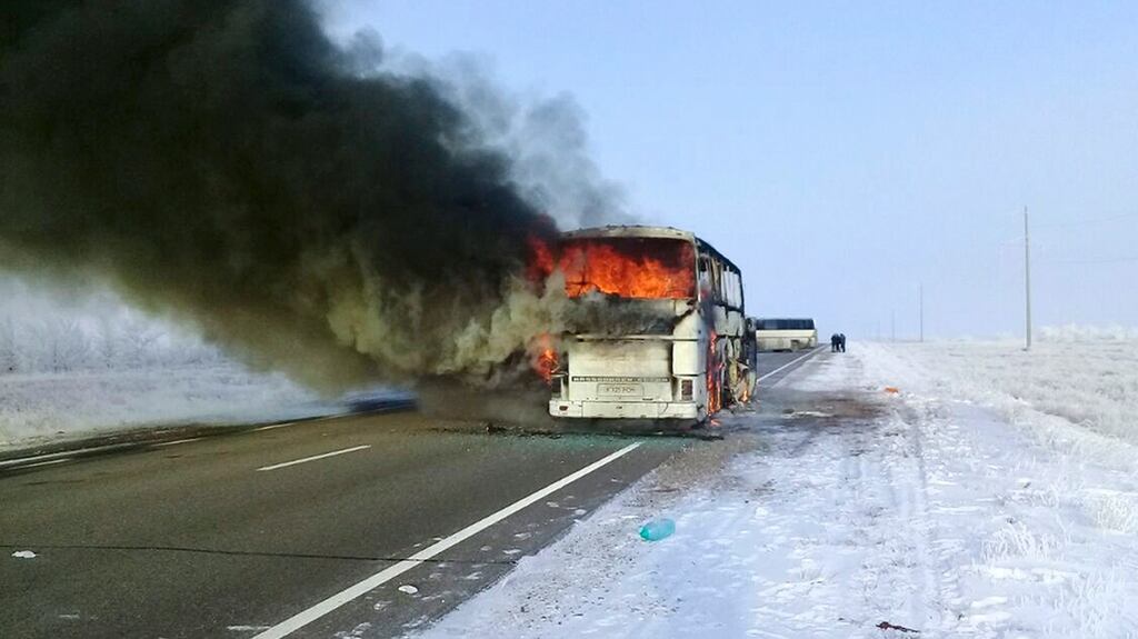 A bus burns on a road near the village of Kalybai in Kazakhstan. Emergency officials say 52 people of 57 on the bus died on the fire. Photograph: Kazakhstan Ministry for Emergency Situations via AP