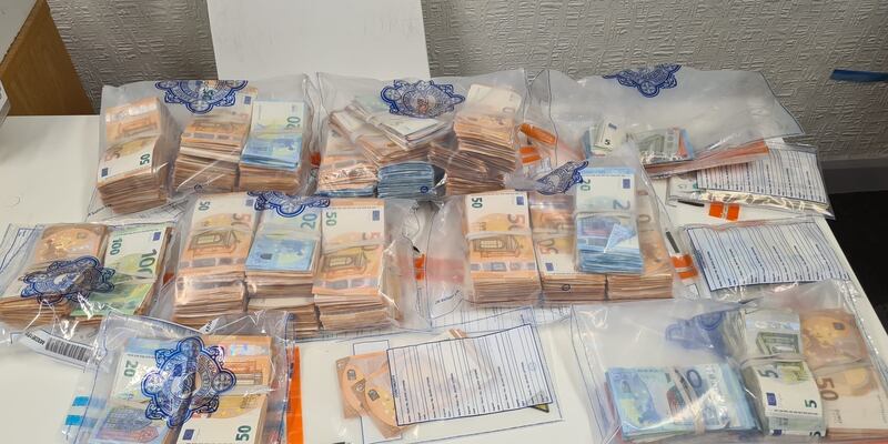 A number of items, including €200,000 cash, 174 rounds of 9mm ammunition and over €20,000 worth of cocaine, seized during searches in west Dublin. Photograph: Garda Press Office
