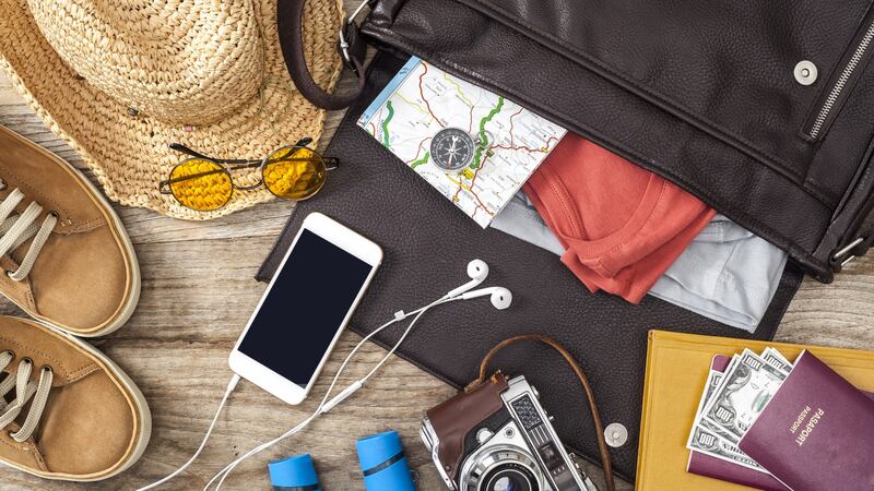 Holiday suitcase on wooden table