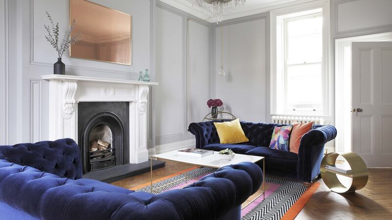 A safe way to play with pattern is to introduce geometrics through a bold rug and then layer up the patterns with cushions