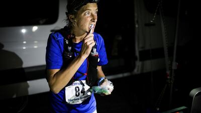 Courtney Dewaulter brushes her teeth at the Spooner Summit, Nevada, aid station at Mile 82 of the Tahoe 200 ultramarathon.