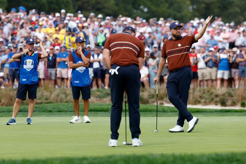 Shane Lowry reacts to the crowd as Rory McIlroy prepares to putt during this year's Ryder Cup. Photograph: Harry How/Getty Images