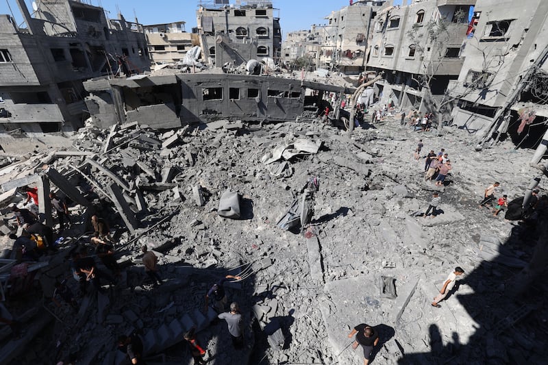 Palestinians inspect the damage after an Israeli strike in the Al-Bureij camp in the central Gaza Strip on Friday. Photograph: Eyad Baba/AFP via Getty Images