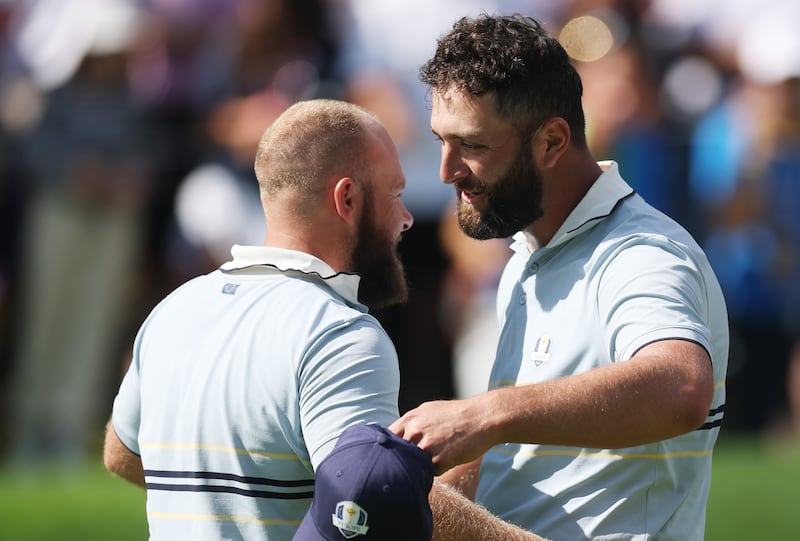 Tyrrell Hatton of and Jon Rahm of Team Europe celebrate defeating Bryson DeChambeau and Justin Thomas. Photograph: Carl Recine/Getty