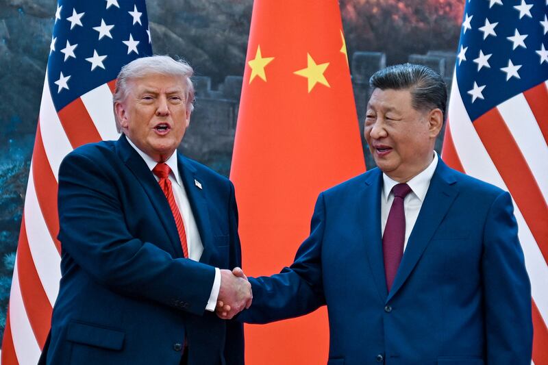 US president Donald Trump shakes hands with Xi Jinping at the Great Hall of the People in Beijing last week. Photograph: Kenny Holston/AFP/Getty Images