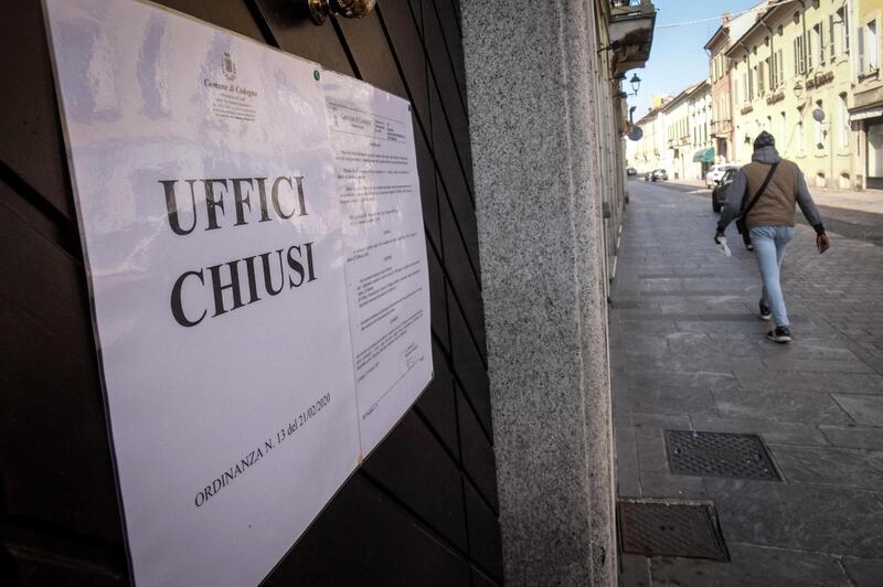 A person walks near a sign that reads ‘offices closed’ in the Codogno,  Italy on February 22nd. Photograph: Matteo Corner/EPA