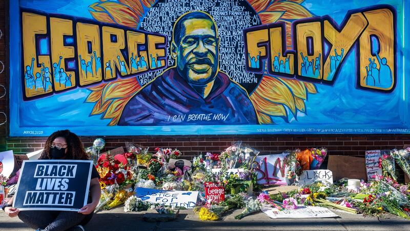 Flowers are left near a makeshift memorial to George Floyd near the spot where he died while in police custody in Minneapolis. Photograph: Kerem Yucel/AFP