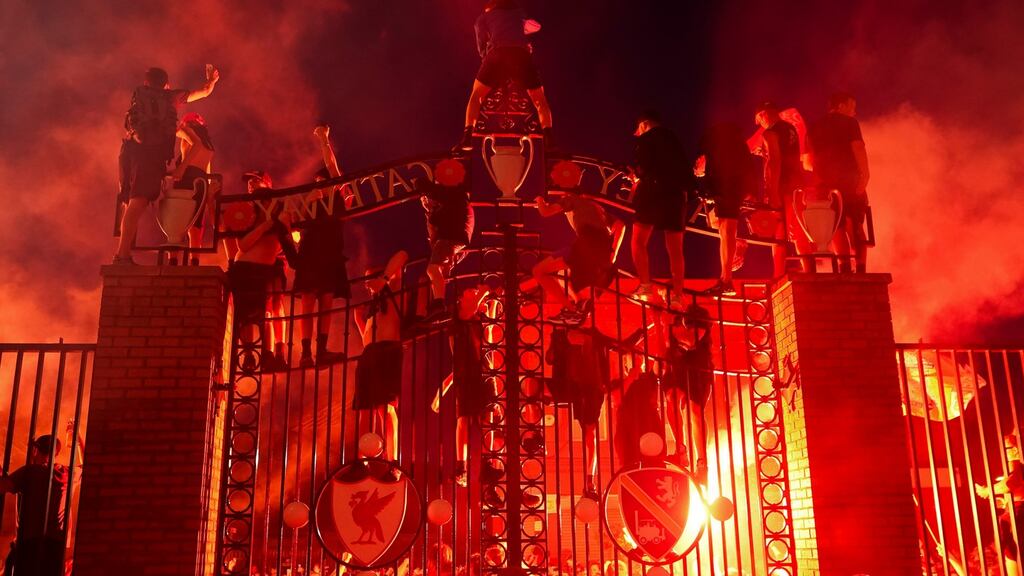 Liverpool fans celebrate outside Anfield after winning the Premier League. Photo: Christopher Furlong/Getty Images