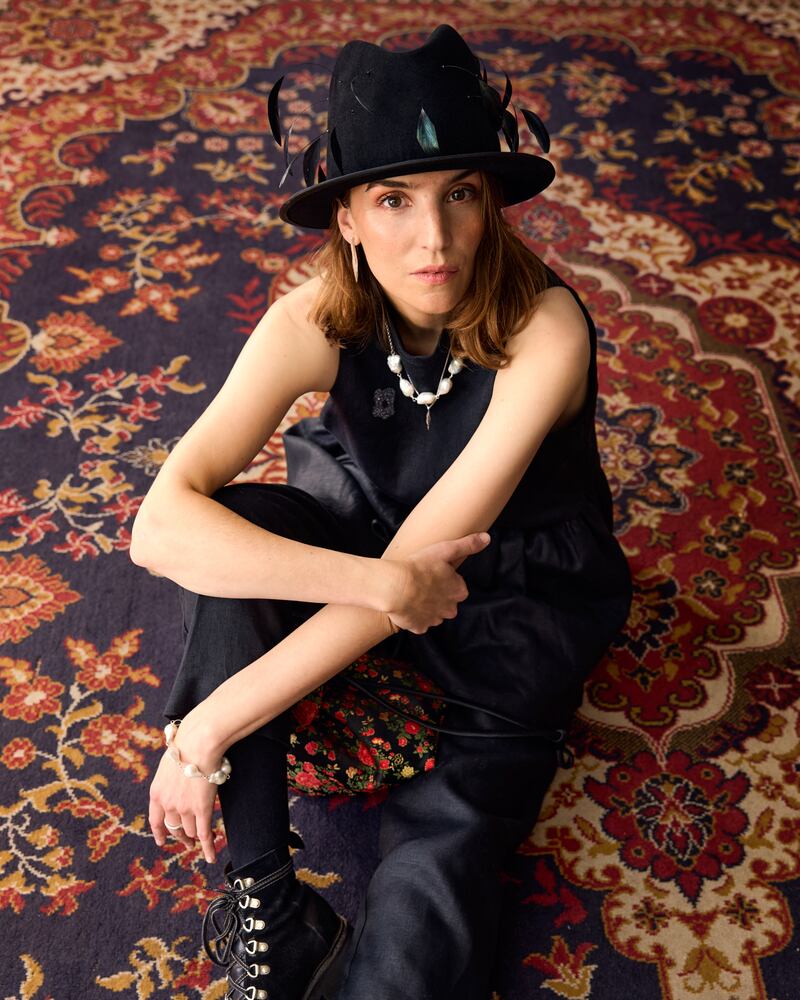 Black feather hat Lucia, €445, FAO Millinery; black top, Jennifer Slattery, €210; earrings €130, baroque pearl necklace, €200, and twisted necklace, €120, all from Inner Island 