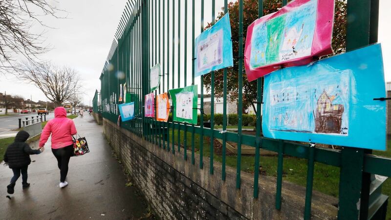 Children’s art hangs on the railing of St Canice’s Boys School in Finglas. The INTO says teachers are concerned about their own safety, the safety of their families, their pupils and their families.  Photograph: Leon Farrell / RollingNews.ie