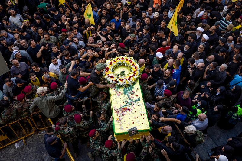 
                        Mourners walk with a coffin during a funeral for four people killed in the pager attack, in Beirut, on Wednesday, Sept. 18, 2024. The Israeli government did not tamper with the Hezbollah phones that exploded, defense and intelligence officials say. It manufactured them as part of an elaborate ruse. (Diego Ibarra Sánchez/The New York Times)
                      