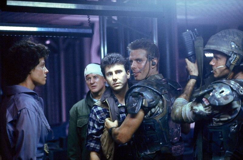 Aliens: Sigourney Weaver as Ellen Ripley, Paul Reiser (centre) as corporate villain Carter Burke, Bill Paxton as Private Hudson and Michael Biehn as Corporal Dwayne Hicks in James Cameron's 1986 sci-fi sequel.