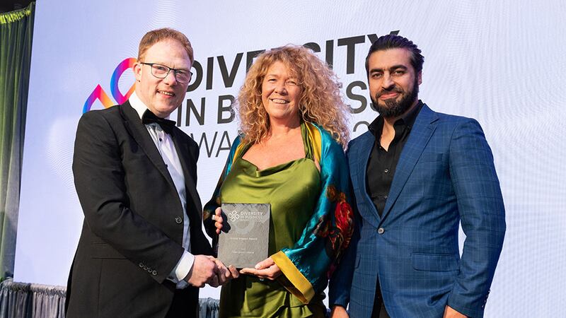 Barry Walsh, awards judge, presents the social impact award to Jeanne McDonagh and Abdul Bari Ahmadzai, Open Doors Initiative