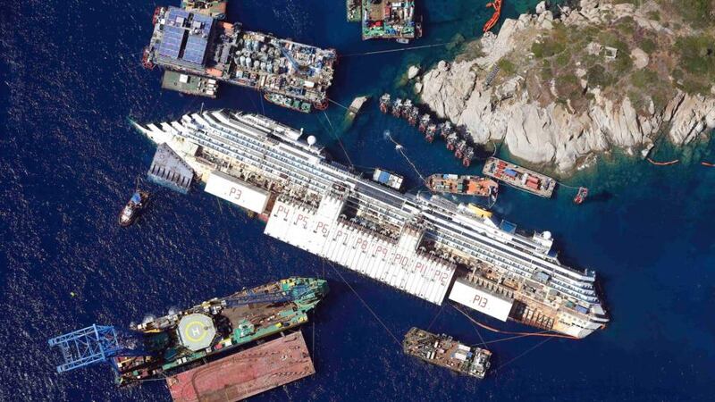 Danger: the cruise ship lies on its side last summer. Photograph: Alessandro Bianchi/Reuters