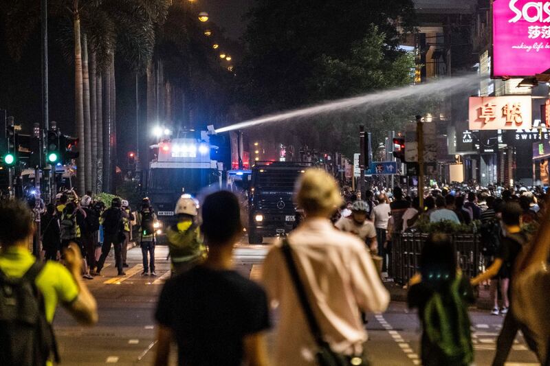 Riot police officers shoot a water canon as they clash with protesters during a march in the Tsim Sha Tsui area of Hong Kong on October 27th. Photograph: Lam Yik Fei/The New York Times