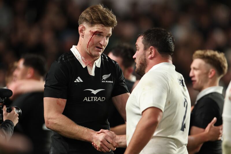Jordie Barrrett of New Zealand shakes hands with Jamie George of England. Photograph: Hannah Peters/Getty Images