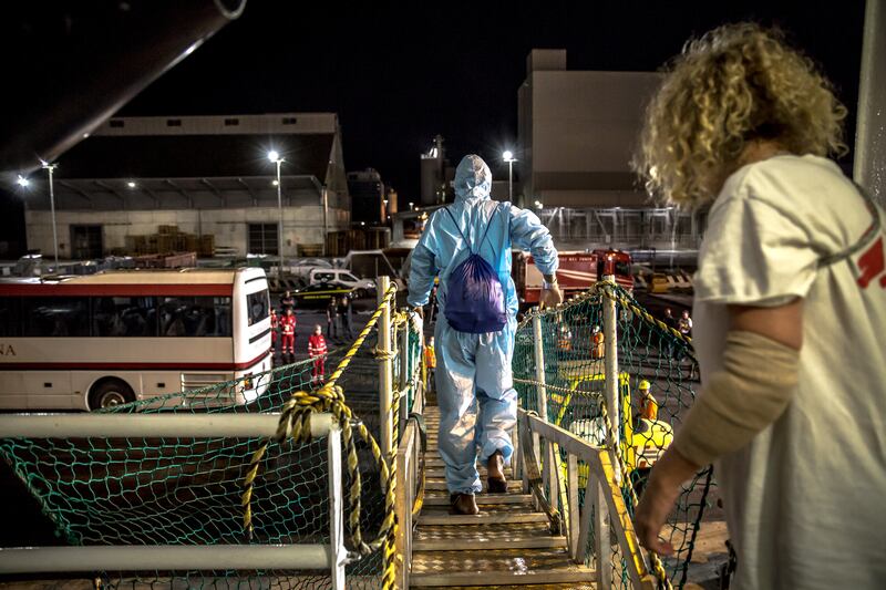 Some of the rescued people disembark the vessel in Ravenna, Italy. Photograph: Sally Hayden