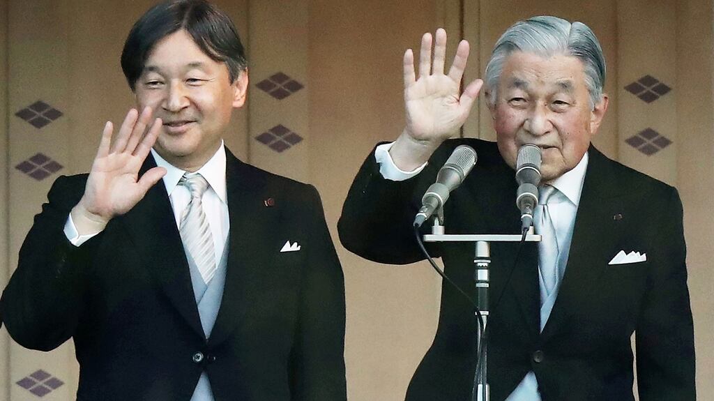 Japan’s Emperor Akihito and Crown Prince Naruhito wave to the crowd during the new year’s greeting ceremony at the Imperial Palace in Tokyo on Wednesday. Photograph: Jiji Press/AFP/Getty Images