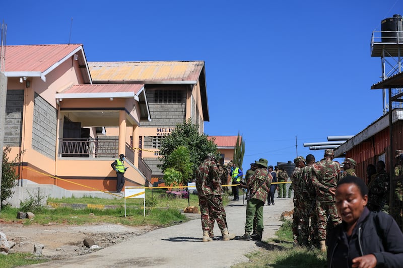 Police officers stand near the scene. Photograph: Andrew Kasuku/AP