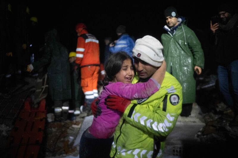 A police officer with his daughter after they saved her from the rubble in Hatay, Turkey. Photograph: Bulent Kilic/AFP via Getty Images