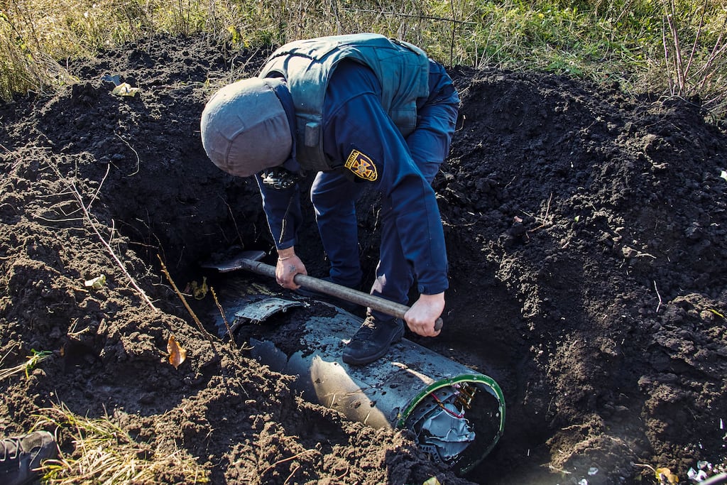 A Ukrainian rescuer digs out part of a shot-down Russian missile in Kharkiv, northeastern Ukraine, on October 18th, 2022. Photograph: EPA
