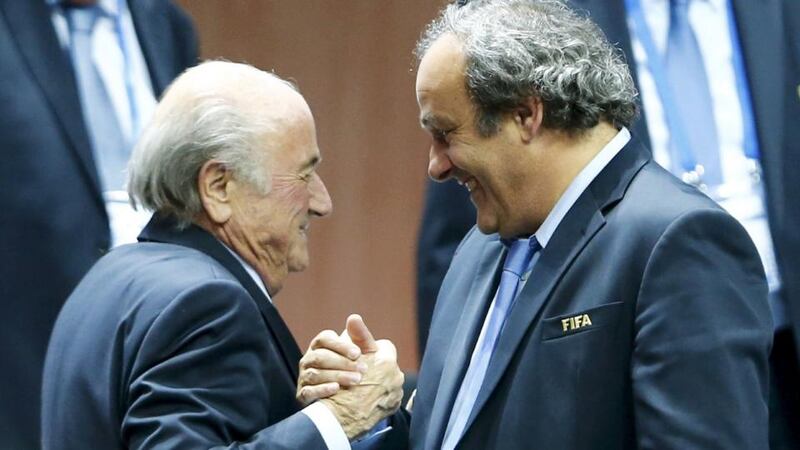 UEFA president Michel Platini (right) congratulates Fifa president Sepp Blatter after he was re-elected at the 65th Fifa Congress in Zurich, Switzerland, on Friday.  Photograph: Reuters
