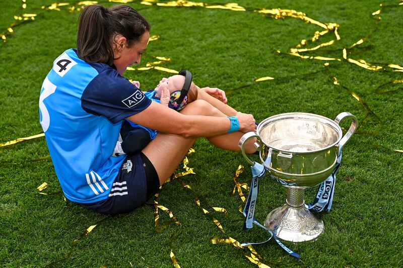 Player of the match Hannah Tyrrell celebrates with her daugher Aoife (7 weeks) alongside the Brendan Martin Cup after victory in the 2023 All-Ireland Senior Championship Final match between Dublin and Kerry at Croke Park. Photograph: Piaras Ó Mídheach/Sportsfile