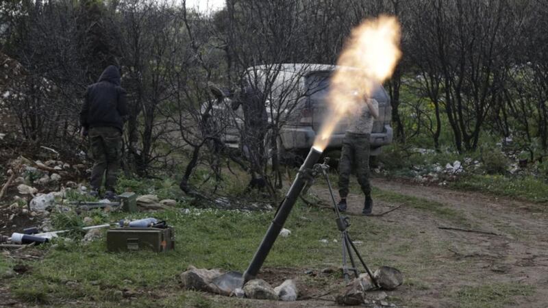 Rebel fighters fire mortar shells at the frontline in the Jabal al-Akrad area in Syria’s northwestern Latakia province. Photograph: Khalil Ashawi/Reuters