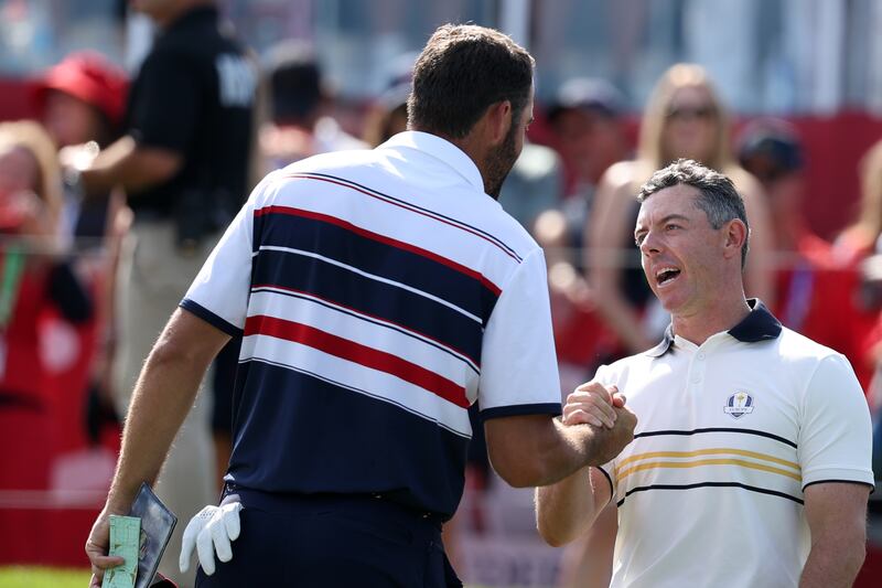 Scottie Scheffler of Team United States and Rory McIlroy of Team Europe shake hands. Photograph: Richard Heathcote/Getty