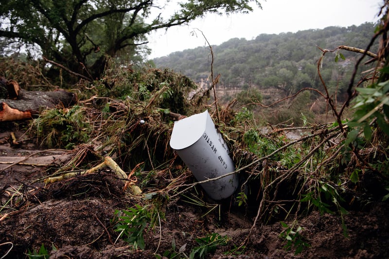 The toppled mailbox for Camp Mystic is surrounded by debris. Photograph: Carter Johnston/The New York Times
                      
