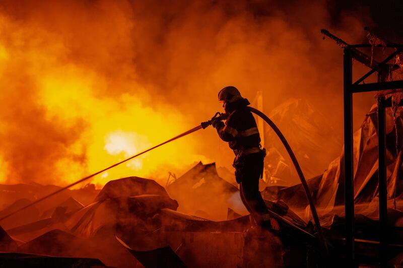 Firefighters tackle a blaze after Russian missiles hit a warehouse in Kyiv, Ukraine. Photograph: Dan Bashakov/AP
