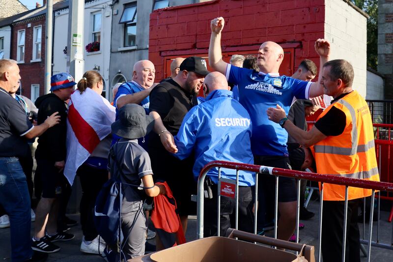 A Linfield fan responds to taunts from Shelbourne supporters at the Champions League tie in Tolka Park. 