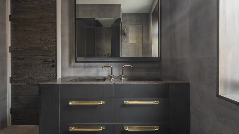 The walls of this master bathroom in a London property, designed by Roseling Wilson, are covered in velvet finish Amaya limestone.