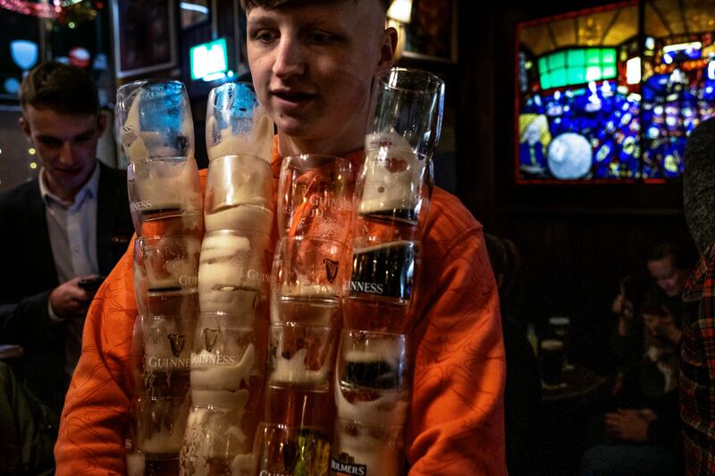 Aaron Bradshaw clears glasses in Grogan’s pub. Photograph: Deanne Fitzmaurice