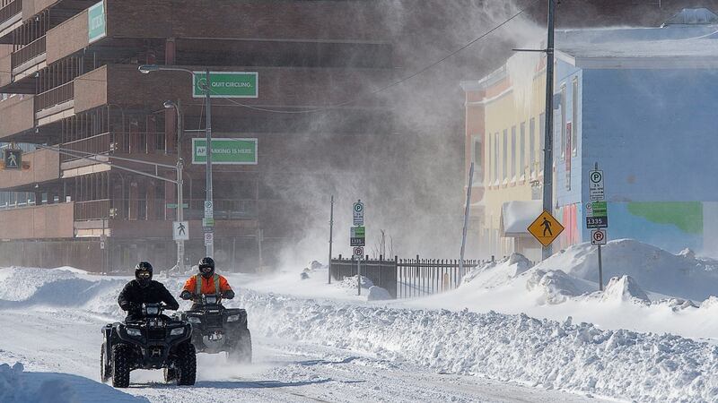 Two all-terrain vehicles cruise through downtown St John’s Newfoundland. Photograph: Andrew Vaughan/The Canadian Press via AP