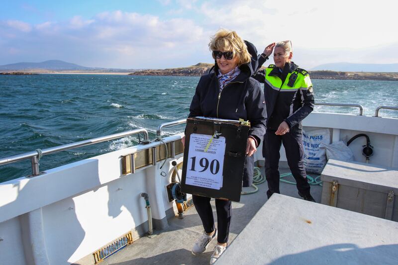 Garda Felicia Coll with Presiding officer Nancy Sharkey, travel with the ballot box from the mainland to Gola Island, off the Donegal coast, on Friday. Photograph: Paul Faith/Getty Images