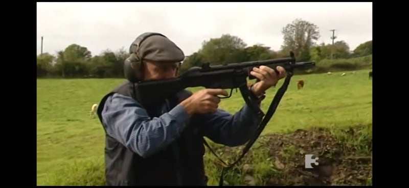 Still image from At Home With the Healy-Raes which aired on TV3 in 2013 showing Michael Healy-Rea shooting the gun at a target.