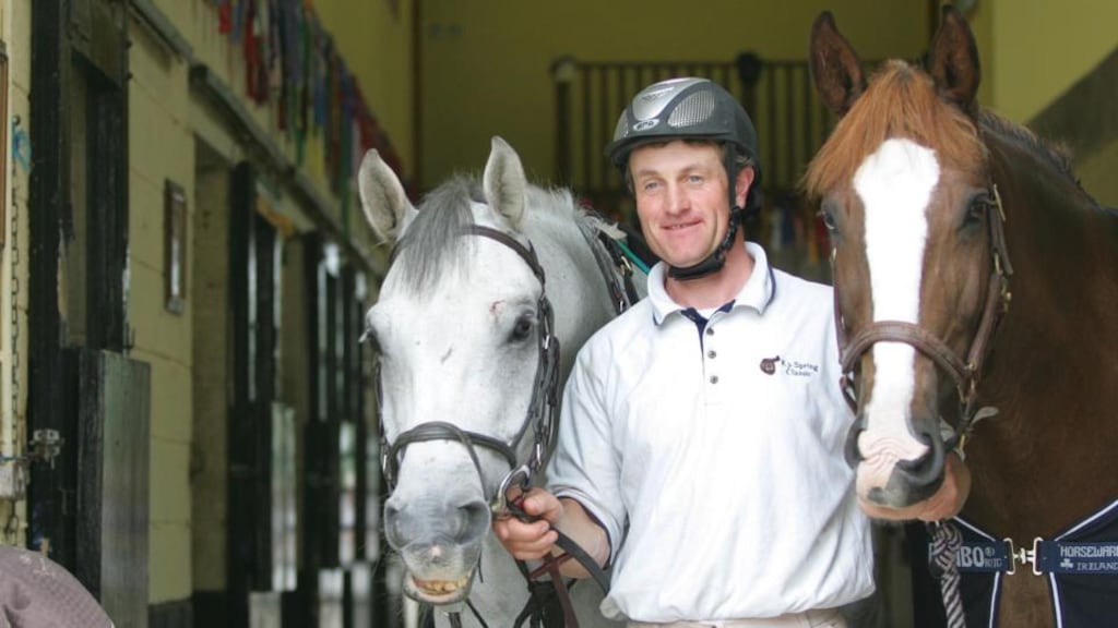 ‘It is a long working day for showjumper John Floody, during which he exercises the horses he competes at national level for various owners and teaches competition riders who come from all over Ireland for jumping tuition.’ Above, John Floody with Womack left and Larkhill Cruiser. Photograph: Brenda Fitzsimons